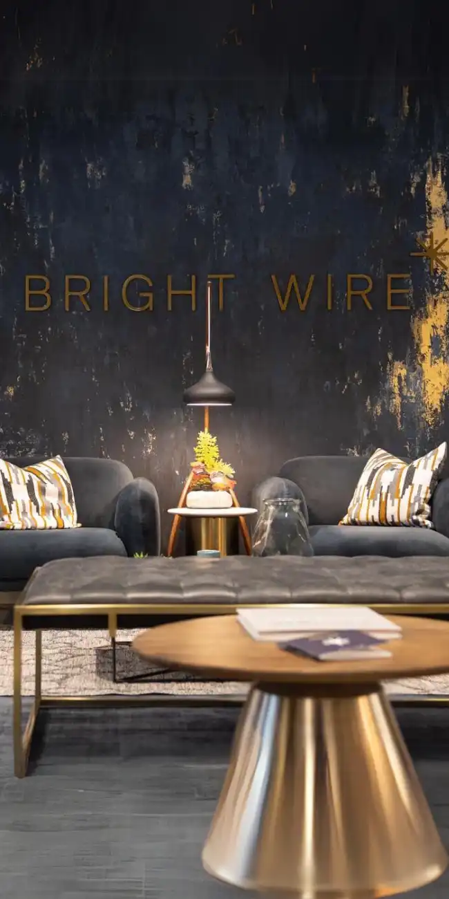 Bright Wire Leadership development office lounge in downtown Calgary, featuring a modern and stylish interior design with navy and gold accents.