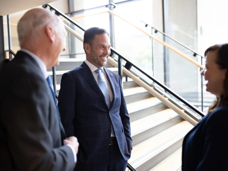 Bright Wire Leadership consultants engaged in a professional conversation near a modern staircase, discussing executive advisory and strategy consulting.