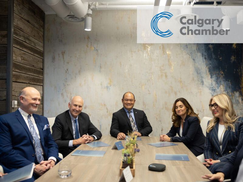 Five Bright Wire Leadership coaches and consultants seated around a conference table, discussing inclusivity and leadership development solutions.