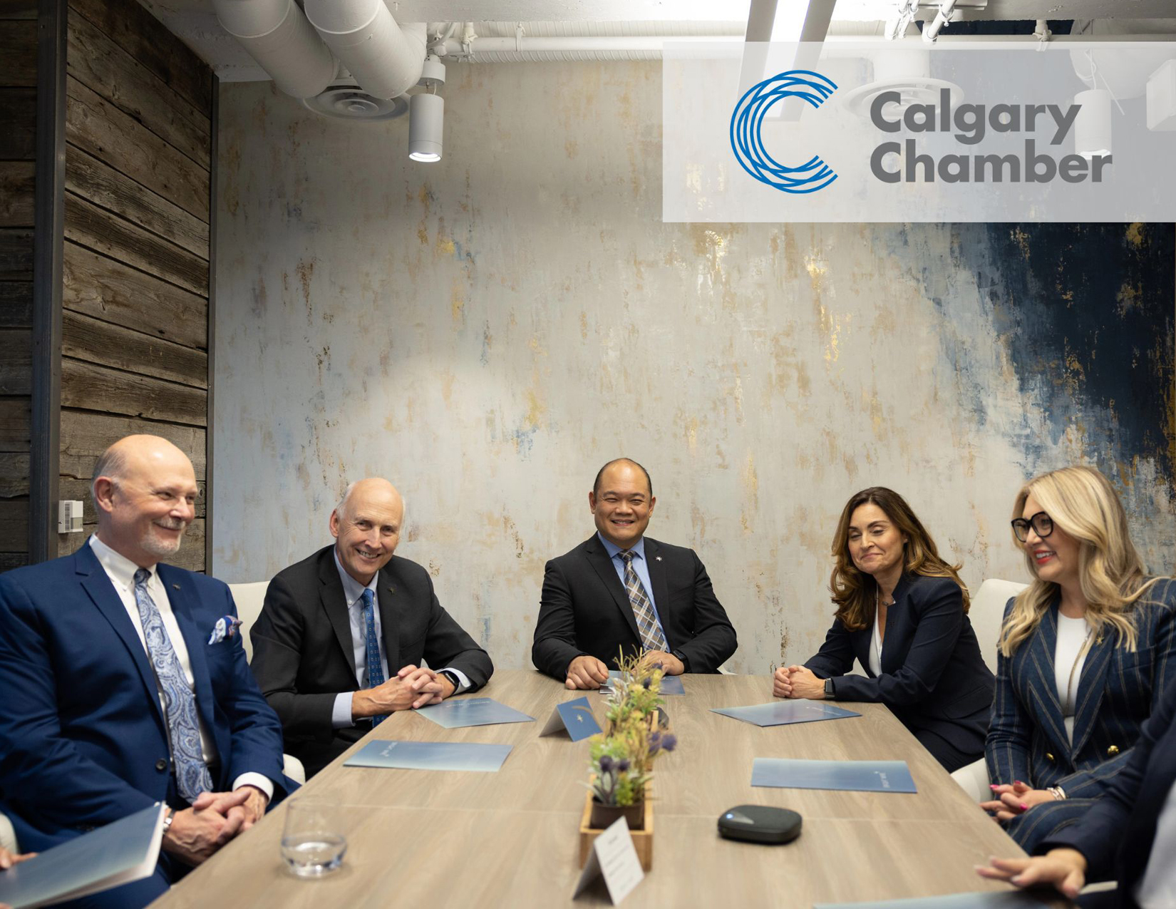 Five Bright Wire Leadership coaches and consultants seated around a conference table, discussing inclusivity and leadership development solutions.